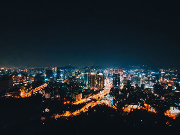 High angle view of illuminated city buildings at night