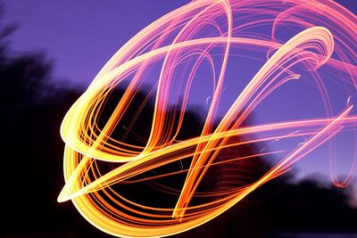 Close-up of light painting against sky at dusk