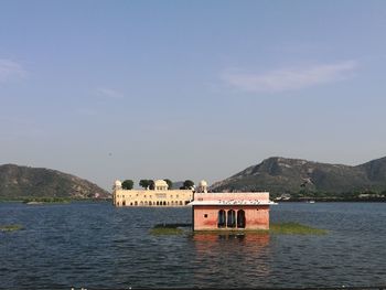 Building by sea against sky