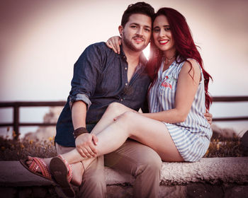 Young couple sitting outdoors