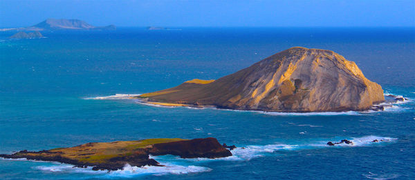 Panoramic shot of headland in calm blue sea