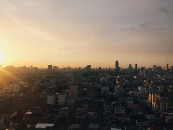 High angle view of cityscape against cloudy sky