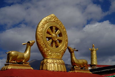 Golden dharma wheel and majestic mountainscape
