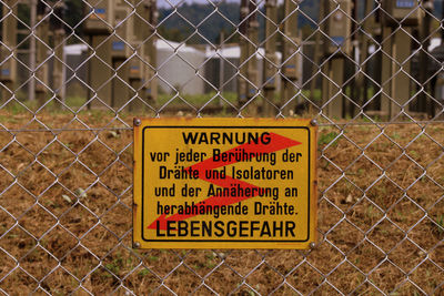 Warning sign on chainlink fence