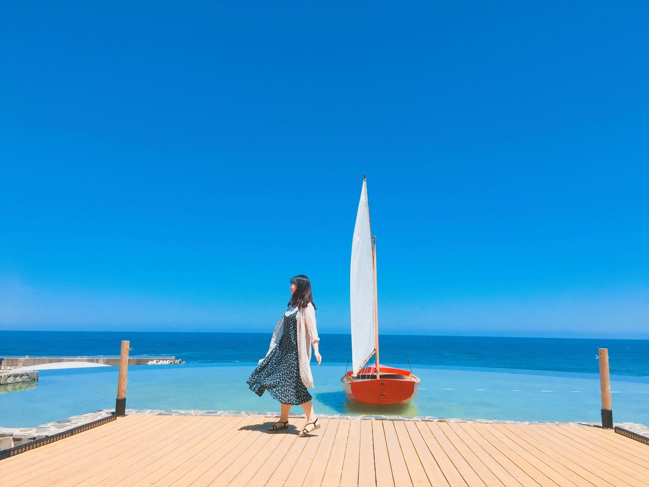 MAN LOOKING AT SEA AGAINST CLEAR SKY