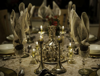 Close-up of illuminated candles on table