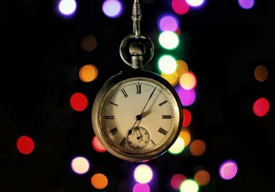 Close-up of illuminated clock at night