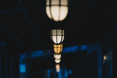 Low angle view of illuminated lighting equipment in row