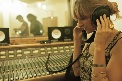 Portrait of a young woman in a recording studio