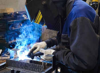 Side view of man working in workshop