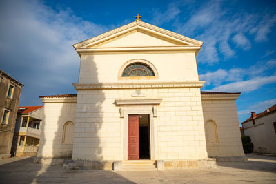 Facade of historic building against sky