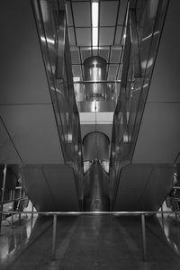 Low angle view of man walking on staircase in building