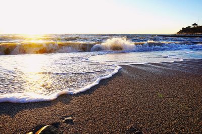 Scenic view of beach against sky during sunset