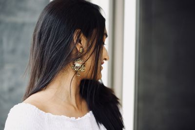 Close-up of young woman wearing earring