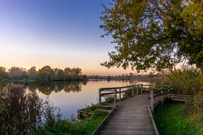 Pier over lake against sky