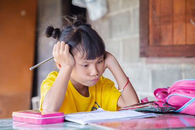 Portrait of a girl sitting on table