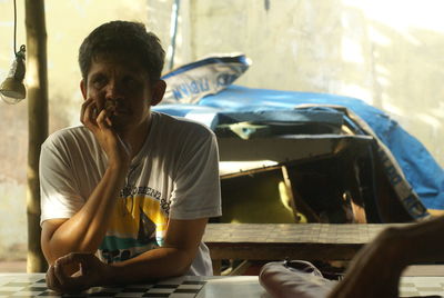 Side view of man looking through car