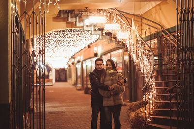 Man and woman standing in illuminated room