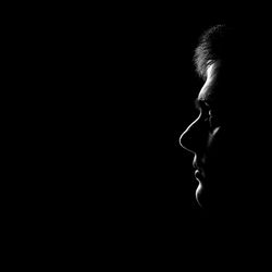 Portrait of man against black background
