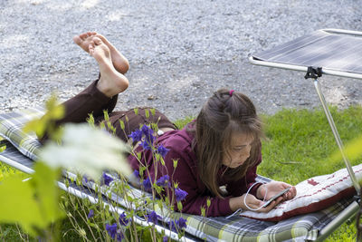 Low angle view of young woman sitting on chair