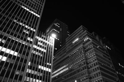 Low angle view of illuminated buildings against sky at night