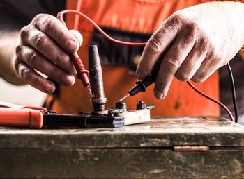 Close-up of man working on machine