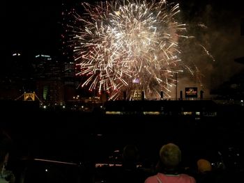 Low angle view of firework display at night