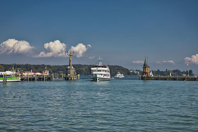 Sailboats in sea against sky