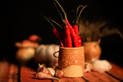 Close-up of red chili peppers on table