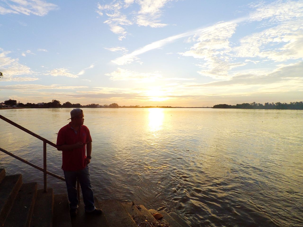 water, sky, sunset, beauty in nature, real people, one person, scenics - nature, cloud - sky, sea, lifestyles, leisure activity, nature, tranquility, standing, rear view, tranquil scene, non-urban scene, beach, outdoors