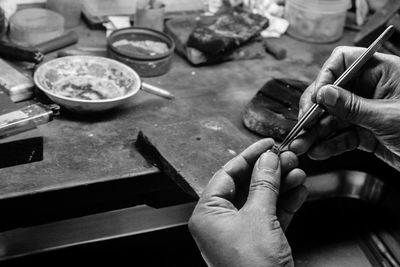 Cropped image of jeweller working in workshop