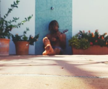 Woman sitting on street in city