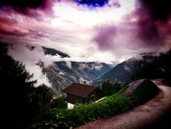 Scenic view of mountains against cloudy sky