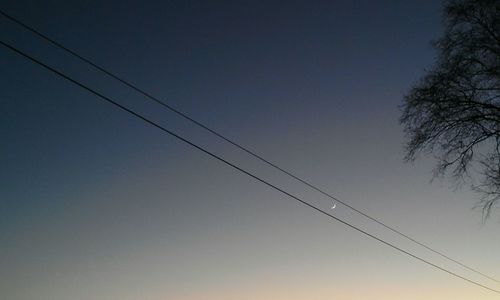 Low angle view of cables against clear sky