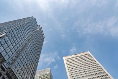 Low angle view of modern buildings against sky in city