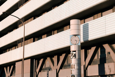 Clock beside japanese building