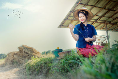 Portrait of woman sitting on field