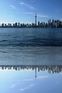 Scenic view of sea and buildings against sky