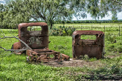 Old abandoned truck on field