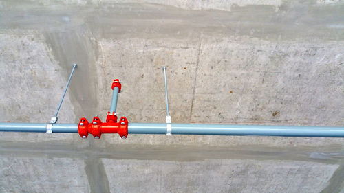 High angle view of red pipe on wall