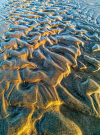 Full frame shot of wet sandy beach