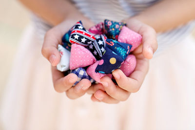 Midsection of woman holding decorations