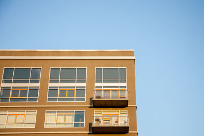 Windows of building against clear sky