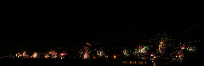 Low angle view of firework display against clear sky at night