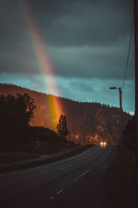 View of rainbow over road against sky