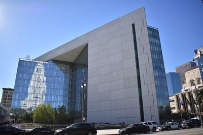 Modern buildings against clear blue sky in city