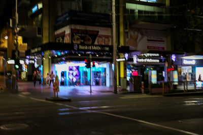 Illuminated city street at night