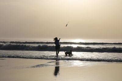 Silhouette of man walking on beach