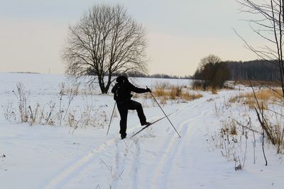 Full length of man on snow field against sky