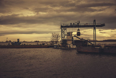 View of harbor against cloudy sky